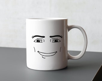 May include: White ceramic mug with a black line drawing of a smiling face. The face has eyebrows, eyes, and a mouth.