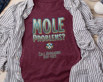 May include: A maroon t-shirt with the text "MOLE PROBLEMS? CALL AVOGADRO 602-1023" and a cartoon image of a bear wearing sunglasses.