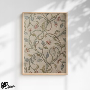 Pode incluir: Uma impressão emoldurada com um padrão floral vintage. O design apresenta vinhas entrelaçadas com folhas verdes, azuis e rosa sobre um fundo bege. A moldura é de madeira clara. A impressão é de fukuoka prints.
