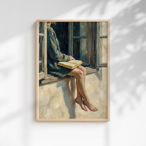 May include: A framed painting depicts a person sitting in a window, reading a book. The person is wearing a green sweater and has their legs dangling outside the window. The painting has a warm, inviting color palette.