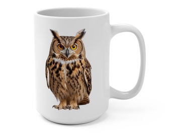 May include: White ceramic mug featuring a brown and white owl printed on the front. The owl has yellow eyes and is looking directly at the viewer.