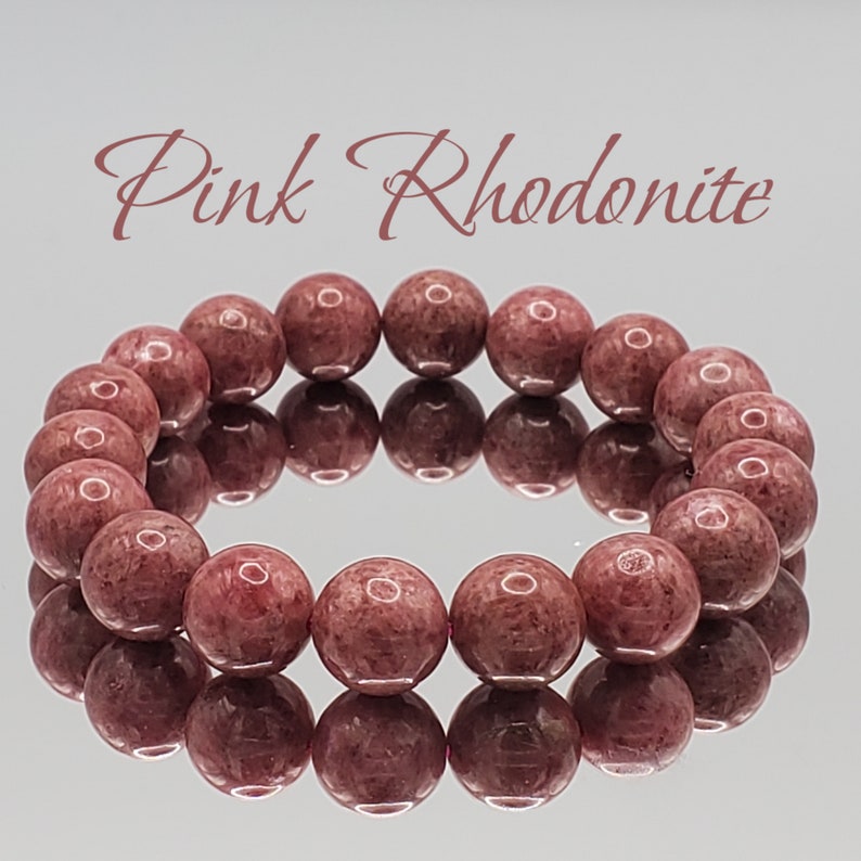 May include: Pink Rhodonite bracelet with round beads. The bracelet is made of natural stones and has a polished finish.