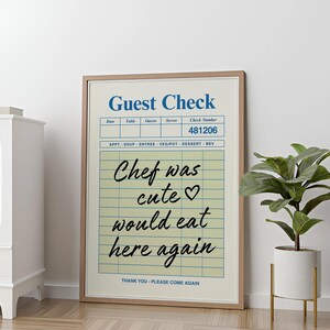 Peut inclure: Une affiche encadrée avec un design de "Guest Check" vintage. Le texte dit "Chef was cute would eat here again." L'affiche a un fond beige avec du texte bleu et noir.