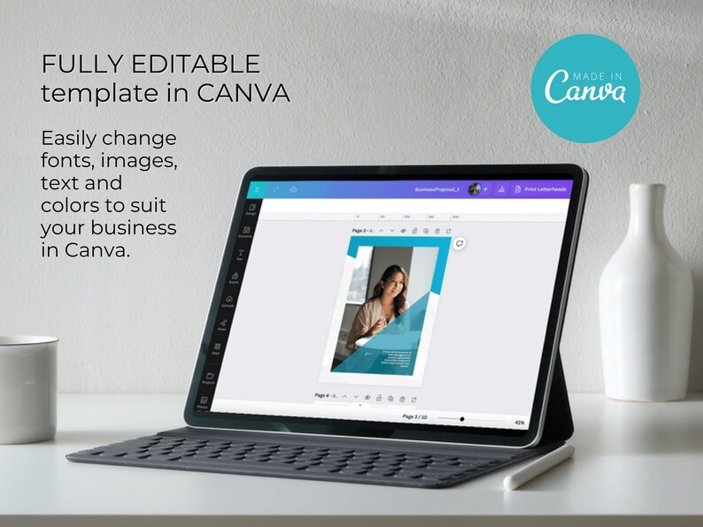 May include: A laptop screen displaying a Canva design template for a business proposal. The template features a woman in a blue shirt and a blue and white background. The text on the screen reads "Business Proposal 2". The laptop is on a white table with a white mug and a white vase.
