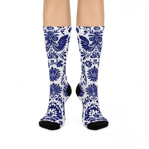 May include: A pair of white socks with a blue floral pattern. The socks are made of a soft, comfortable material and are perfect for everyday wear.