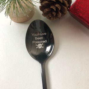 May include: Black metal spoon with the text "You Have Been Poisoned" and a skull and crossbones design.