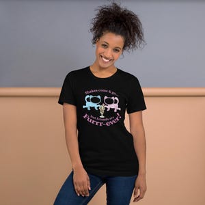 May include: A black t-shirt with a graphic of two cartoon cats holding ice cream cones. The text on the shirt reads "Shakes come & go... but Friends are Furrr-ever!"
