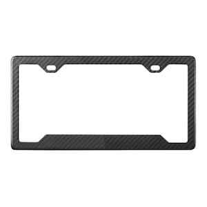 May include: A rectangular license plate frame with a carbon fiber weave pattern. The frame has a black finish and features two mounting holes at the top and a cutout at the bottom.