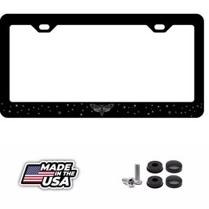 May include: Black license plate frame with a moth design and star accents. Includes mounting hardware and a "Made in the USA" sticker.
