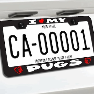 May include: A black number plate surround featuring the white text I MY PUGS with red heart icons and paw prints. The top centre displays the text I MY with a red heart, and the bottom centre features the word PUGS with red heart and paw accents.