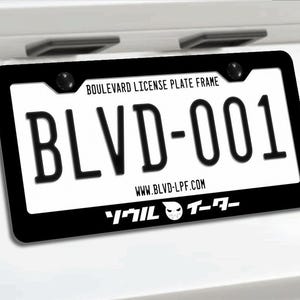 May include: Black license plate frame with the text "BLVD-001" in bold, white letters. The frame also includes the text "Boulevard License Plate Frame" and "www.BLVD-LPF.com". A stylized graphic is at the bottom.