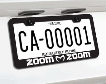 Reflekterande vit zoom zoom mazda m-logotyp svart metallram med registreringsskylt och skruvar