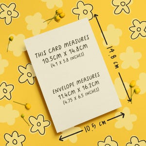 May include: A cream-colored card with text indicating dimensions: 4.1 x 5.8 inches. The envelope measures 4.75 x 6.5 inches. The card and envelope are on a yellow background with flower and bud illustrations.