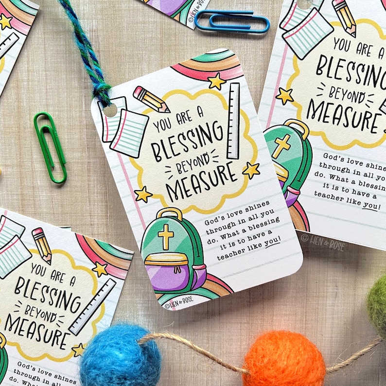May include: Several gift tags with the message "You are a blessing beyond measure" are displayed. Each tag features a backpack, pencil, ruler, and notebook illustrations. The tags are connected with a teal string and surrounded by colorful felt balls.