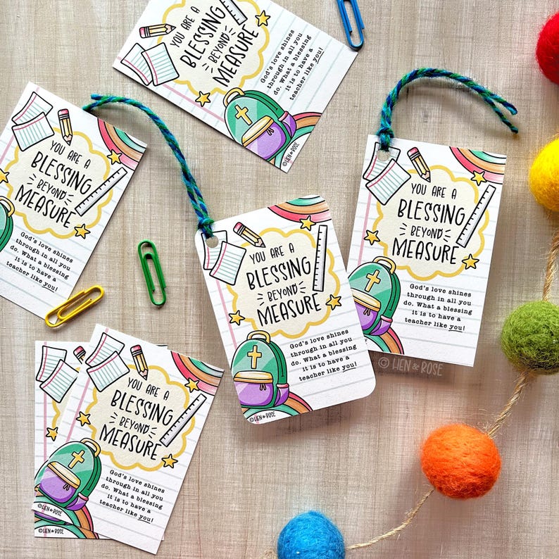 May include: White gift tags with the text "YOU ARE A BLESSING BEYOND MEASURE" and illustrations of a backpack, pencil, and ruler. The tags have a rainbow and star design, and are tied with blue and green twine.