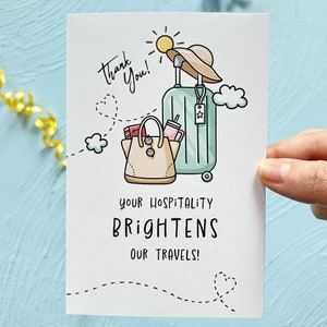 May include: A thank you card with a cartoon illustration of a suitcase, a purse, and a sun. The text on the card reads "Thank You! Your hospitality brightens our travels!"
