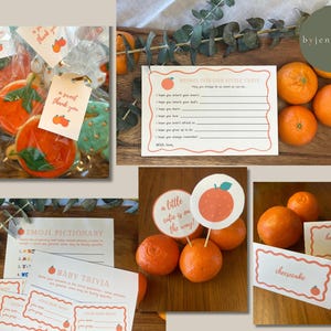 May include: A collection of baby shower items featuring orange-themed decorations and treats. The image includes cookies, cards with text, and fresh tangerines. The cards display text such as "thank you", "a sweet thank you", "Wishes for our little cutie", "Emoji Pictionary", "Baby Trivia", and "cheesecake".