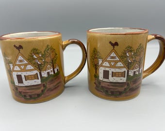 Otigari Japanese pottery coffee mugs featuring owls and birds in trees outside of cottages