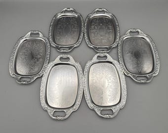 Set of 6 silver plated serving trays with ornate etched handles and floral detailed centers