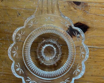 Glass chamber stick holder with attached glass handle and scalloped edges