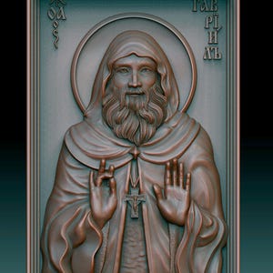 Puede incluir: Escultura en relieve detallada de una figura religiosa, con un hombre barbudo con una túnica con capucha. La escultura tiene un halo y un colgante de cruz. El fondo es de color verde azulado oscuro y la escultura es de color bronce.