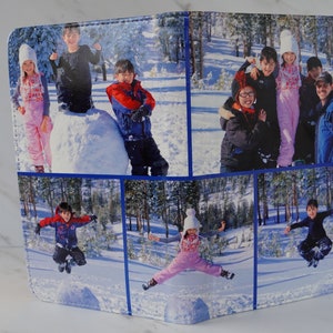 May include: A collage of six photographs featuring a family of five enjoying a snowy day. The photographs show the family playing in the snow, building a snowman, and jumping in the air. The photographs are printed on a white background with blue borders.