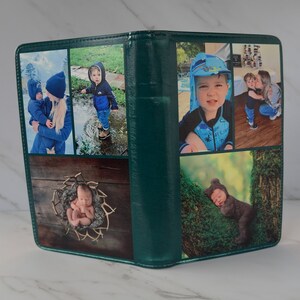 May include: A green photo album featuring six images of children. The photos depict a baby in a basket, a baby wearing a bear costume, a child in a blue jacket, a child in a blue swimsuit, and two children embracing.