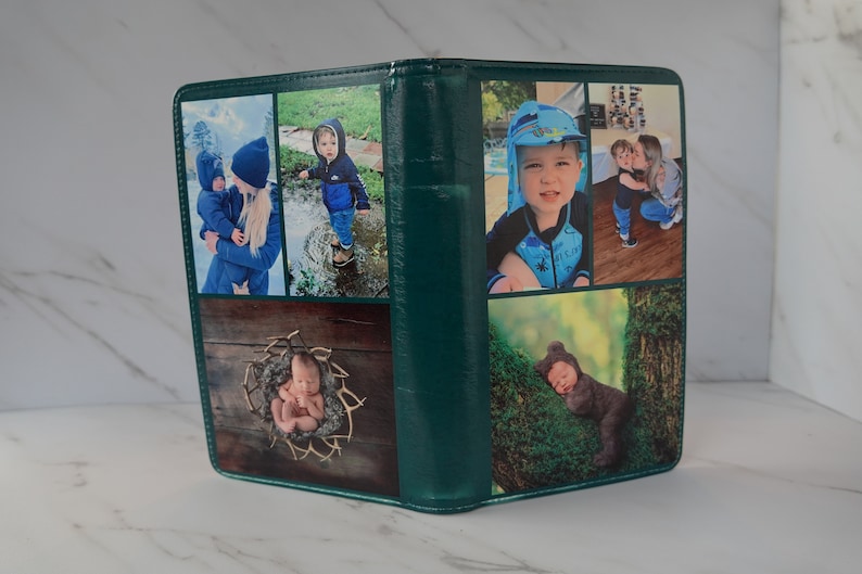 May include: A green photo album featuring six images of children. The photos depict a baby in a basket, a baby wearing a bear costume, a child in a blue jacket, a child in a blue swimsuit, and two children embracing.