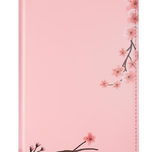 May include: A pink phone case featuring a floral design of cherry blossoms. The case has a smooth finish and a stitched edge. The cherry blossom branches are brown with pink flowers.