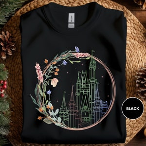 a black t - shirt with a picture of a castle in the middle of it