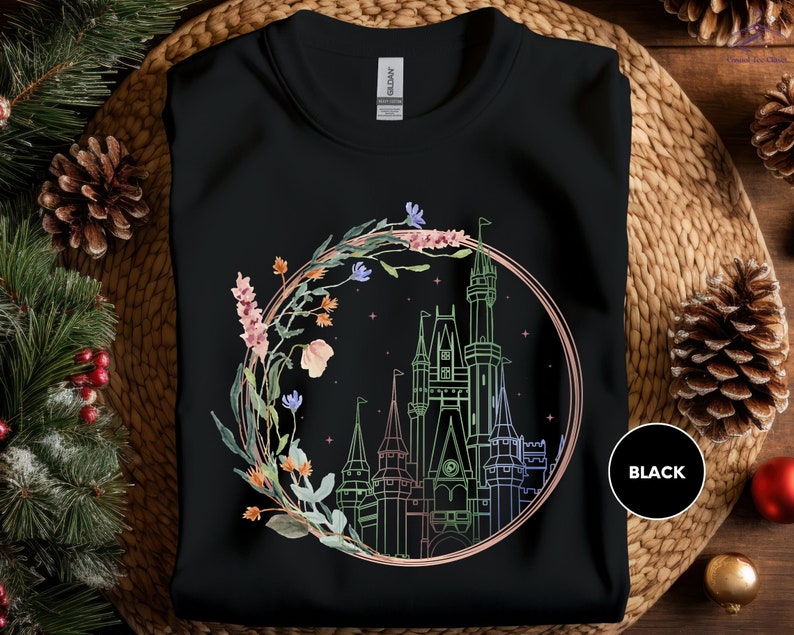 a black t - shirt with a picture of a castle in the middle of it