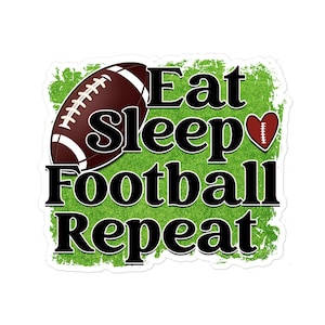 May include: A sticker featuring a brown football and a heart-shaped football icon over a green textured background. The text reads Eat Sleep Football Repeat in bold black letters with a white outline, arranged in four lines across the design.