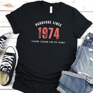 May include: Black t-shirt with a red graphic that says "Hardcore Since 1974 - Living Legend for 50 Years - "