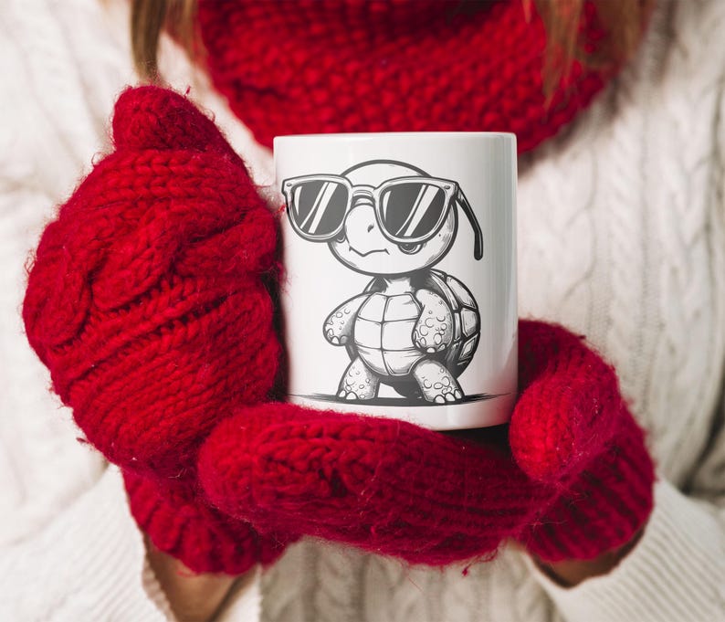 May include: A white ceramic mug with a black and white illustration of a turtle wearing sunglasses. The turtle is standing on its hind legs and has a shell with a pattern. The mug is being held by a person wearing red knitted mittens.