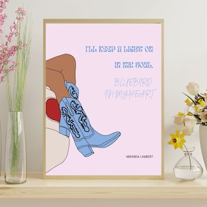 May include: A pink printable wall art print with a line drawing of a woman wearing blue cowboy boots. The text reads "I'll keep a light on in my soul, Bluebird in my heart - Miranda Lambert".