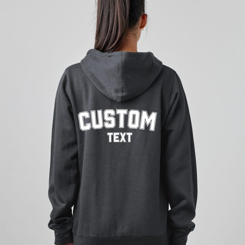 May include: A black hooded sweatshirt with a white "CUSTOM TEXT" graphic on the back.