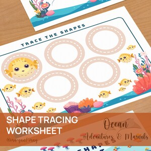 May include: A printable worksheet for kids to trace circles. The worksheet features a cartoon pufferfish and coral reef design. The text "Trace the Shapes" and "Shape Tracing Worksheet" is included on the page.