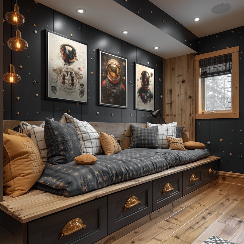 May include: A dark gray daybed with a black and white patterned cushion and a yellow throw pillow. The daybed is against a black wall with three framed prints of astronauts in space suits. The wall is decorated with gold stars.