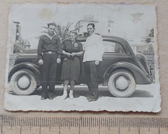 Old photo Sailors uniform with woman.Auto Opel