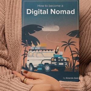 May include: A book cover with a blue background and the title "How to become a Digital Nomad" in white text. The cover features an illustration of a person working on a laptop in a car with palm trees in the background.