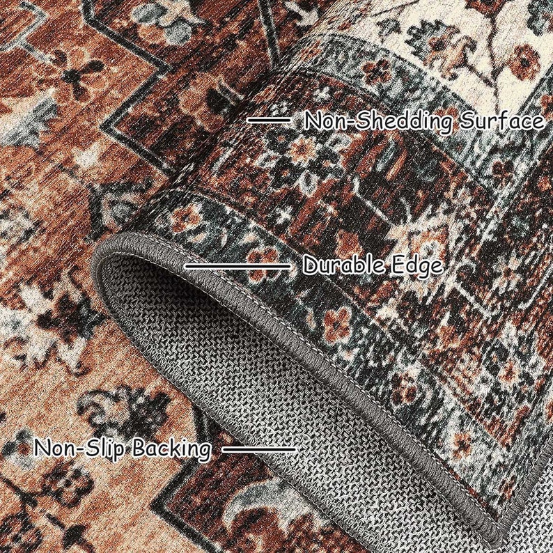 May include: Close-up of a rug with a brown and blue patterned design. The rug has a non-shedding surface, a durable edge, and a non-slip backing.