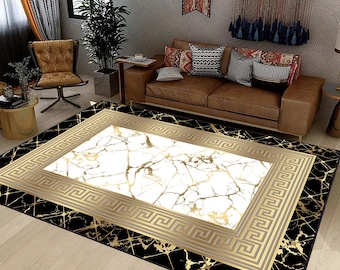 May include: A black and gold area rug with a white marble pattern in the center. The rug has a geometric border with a Greek key design.