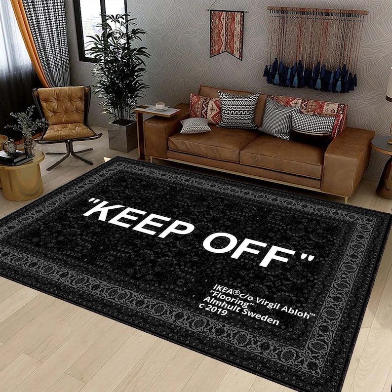 K&ouml;nnte beinhalten: Schwarz-wei&szlig;er Teppich mit floralem Muster und dem Text "KEEP OFF" in Wei&szlig;. Der Teppich enth&auml;lt auch den Text "IKEA&reg;c/o Virgil Abloh&trade; "Flooring" Almhult Sweden c 2019".