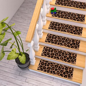 May include: A set of five brown and black leopard print stair treads. The treads are made of a soft, plush material and are designed to protect your stairs from wear and tear.