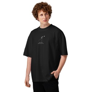 May include: Black oversized t-shirt with a small white graphic and the text "THE BOY FROM BLYTH". The shirt has short sleeves and a relaxed fit. The fabric appears to be a soft, comfortable material.