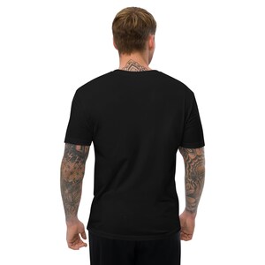 May include: A black short-sleeved t-shirt. The back of the shirt is visible, with a crew neck and a simple, solid design. The shirt is made of a soft, comfortable material.