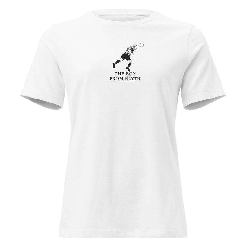 May include: White t-shirt with a black and white graphic of a footballer kicking a ball. The text "THE BOY FROM BLYTH" is printed below the image. The shirt has short sleeves and a round neck.