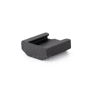 May include: A black plastic camera accessory with a textured surface.