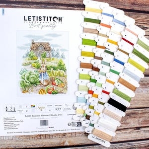 May include: A cross stitch kit featuring a colorful illustration of a rabbit in a garden with a house in the background. The kit includes a variety of DMC threads and a printed fabric. The kit is titled "Summer Harvest" and is by Letistitch.