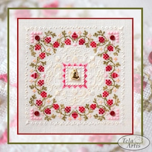 May include: Square cross-stitch embroidery with a floral design. The embroidery features a central square with a gold heart charm, surrounded by a pink border. A wreath of red flowers and green leaves frames the central design. The background is off-white.
